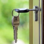 Key hanging from a door representing successful property transactions in Vancouver with the help of a real estate lawyer.